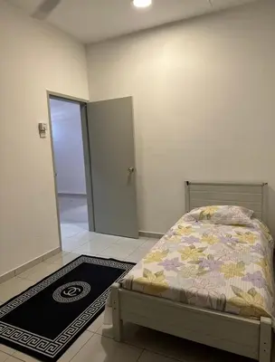 a bedroom with a bed and a door to a hallway at Aura Homestay in Sungai Petani