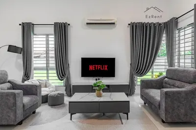 a living room with two couches and a tv at Black & White 4BR Semi-D Home for 10 Guests with Pool Table Games & Free Netflix WiFi in Taiping