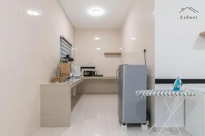 a white kitchen with a refrigerator and a counter at Black & White 4BR Semi-D Home for 10 Guests with Pool Table Games & Free Netflix WiFi in Taiping