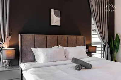 a bedroom with a large bed with white pillows at Black & White 4BR Semi-D Home for 10 Guests with Pool Table Games & Free Netflix WiFi in Taiping