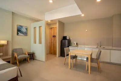 a room with a kitchen and a table and chairs at Zenith Suites Cameron in Tanah Rata