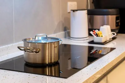 a pot on top of a stove in a kitchen at Zenith Suites Cameron in Tanah Rata