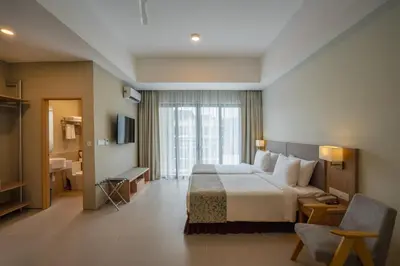 a hotel room with a bed and a bathroom at Zenith Suites Cameron in Tanah Rata