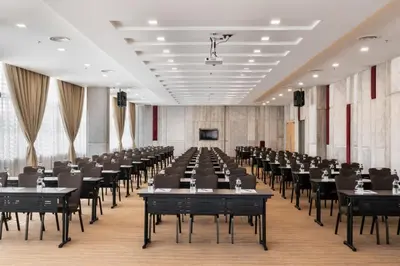 an empty banquet hall with tables and chairs at Zenith Suites Cameron in Tanah Rata