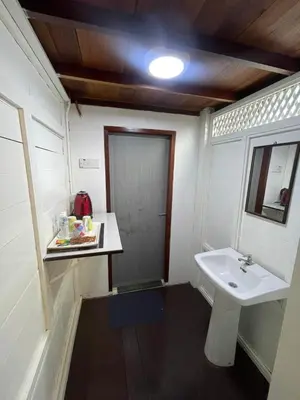 a small bathroom with a sink and a mirror at Nami Homestay Teluk Batik in Lumut