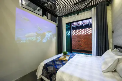 a bedroom with a large window with an aquarium at 35 Cozy Homestay with projector Pool BBQ evcharger in Ipoh