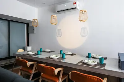 a dining room with a long table and chairs at 35 Cozy Homestay with projector Pool BBQ evcharger in Ipoh