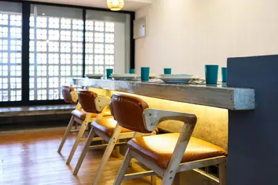a row of chairs at a bar in a restaurant at 35 Cozy Homestay with projector Pool BBQ evcharger in Ipoh