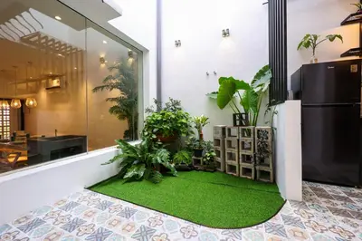 a room with a green floor with plants in it at 35 Cozy Homestay with projector Pool BBQ evcharger in Ipoh