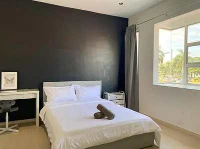 a bedroom with a bed with a teddy bear on it at IKEA Modernism House 10Pax`Near Icon City in Bukit Mertajam