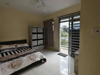 a bedroom with a bed and a sliding glass door at City View Apartment in Ipoh