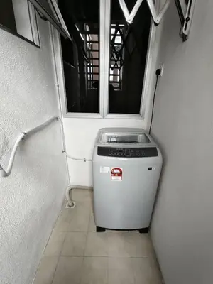 a laundry room with a washer and a window at City View Apartment in Ipoh