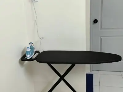 a black bench sitting next to a wall at City View Apartment in Ipoh