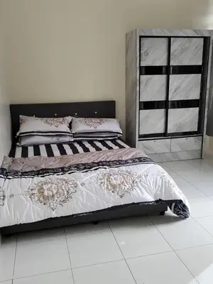 a bed in a room with a white floor at City View Apartment in Ipoh