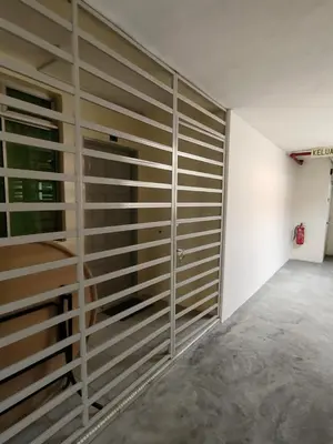 a room with a wall of sliding doors at City View Apartment in Ipoh