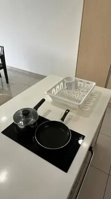 a stove top with two pans on a kitchen counter at Southbay Seaview Condo A10 10minQueensbay 10minSpice in Bayan Lepas