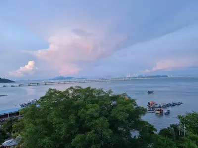 a bridge over a large body of water with boats at Southbay Seaview Condo A10 10minQueensbay 10minSpice in Bayan Lepas