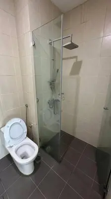 a bathroom with a toilet and a glass shower stall at Southbay Seaview Condo A10 10minQueensbay 10minSpice in Bayan Lepas