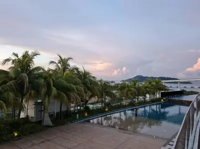 a view of a swimming pool with palm trees at Southbay Seaview Condo A10 10minQueensbay 10minSpice in Bayan Lepas