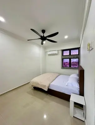 a bedroom with a bed and a ceiling fan at Pengo Homestay Georgetown in George Town