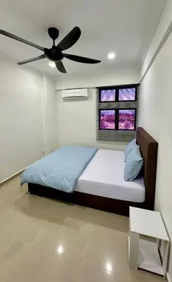 a bedroom with a bed with a ceiling fan at Pengo Homestay Georgetown in George Town