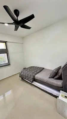 a bedroom with a bed and a ceiling fan at Pengo Homestay Georgetown in George Town