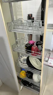 a shelf with plates and dishes in a refrigerator at Pengo Homestay Georgetown in George Town