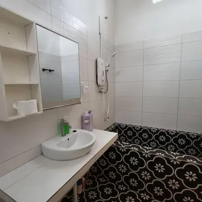 a white bathroom with a sink and a mirror at Getaway Hometsay Neaby Beach batu Ferringghi 4BR for 15px in Tanjung Bungah