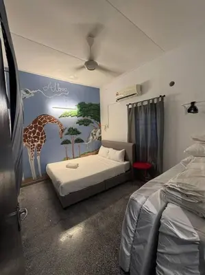 a bedroom with a giraffe mural on the wall at Getaway Hometsay Neaby Beach batu Ferringghi 4BR for 15px in Tanjung Bungah