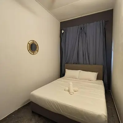 a bed with a teddy bear sitting on top of it at Getaway Hometsay Neaby Beach batu Ferringghi 4BR for 15px in Tanjung Bungah