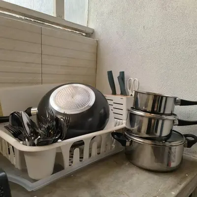 a shelf with dishes and utensils on a kitchen counter at Getaway Hometsay Neaby Beach batu Ferringghi 4BR for 15px in Tanjung Bungah