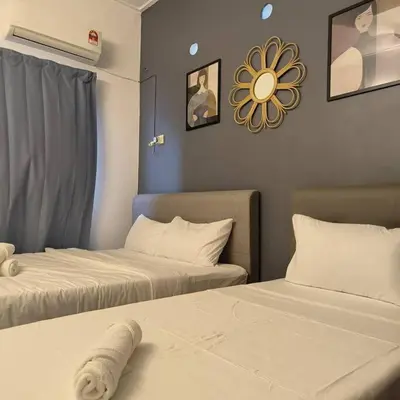 a room with two beds and a mirror on the wall at Getaway Hometsay Neaby Beach batu Ferringghi 4BR for 15px in Tanjung Bungah