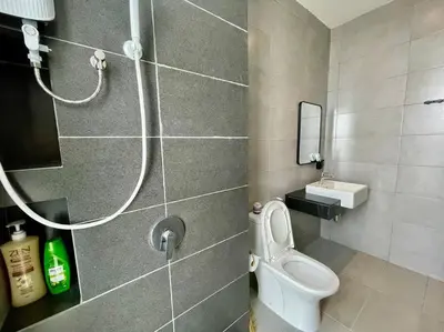 a bathroom with a toilet and a shower at Industrial Style 2 Bedroom Unit Urban Suites Georgetown Sea View Jelutong in Jelutong