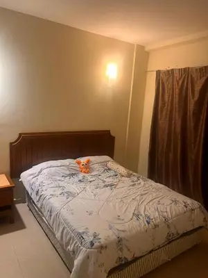 a bed with a stuffed animal on top of it at A sweet home for your trip in Lumut