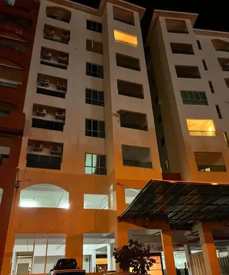 a building with a car parked in front of it at A sweet home for your trip in Lumut