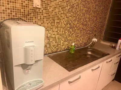 a kitchen with a mixer and a sink at A sweet home for your trip in Lumut