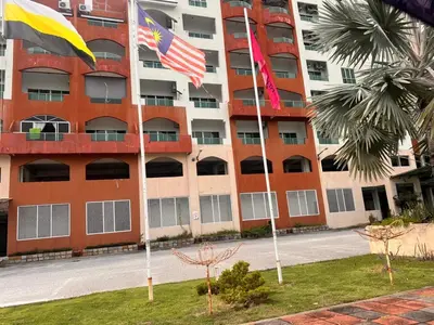 two flags are flying in front of a building at A sweet home for your trip in Lumut