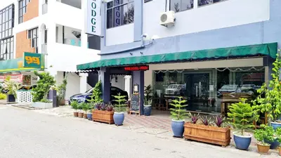 a street with plants in pots in front of a store at Pine Lodge BY EVR Previously YSS indrawasih in Perai