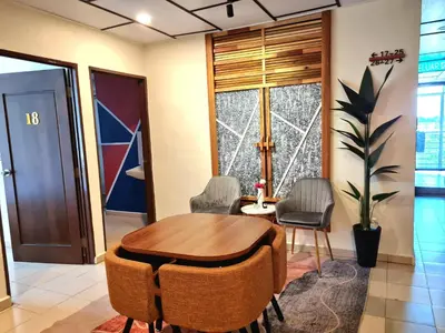 a meeting room with a wooden table and chairs at Pine Lodge BY EVR Previously YSS indrawasih in Perai
