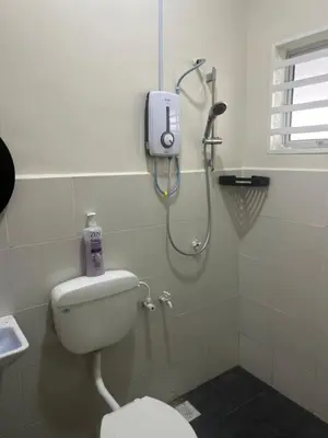 a bathroom with a shower and a toilet in it at SKV Homestay in Teluk Intan
