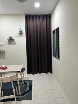 a room with a table and a black curtain at SKV Homestay in Teluk Intan