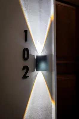 a clock with a light on a wall at Aayu Muntri - 4 mins to Chulia St George Town in George Town