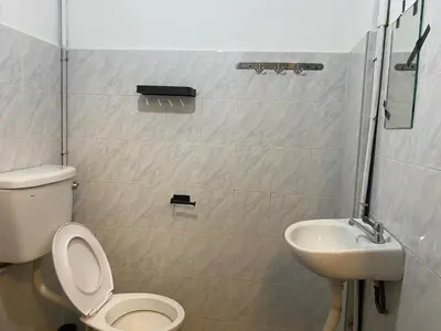 a bathroom with a toilet and a sink at Aayu Muntri - 4 mins to Chulia St George Town in George Town