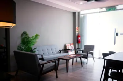 a living room with a couch and chairs and a table at Aayu Muntri - 4 mins to Chulia St George Town in George Town