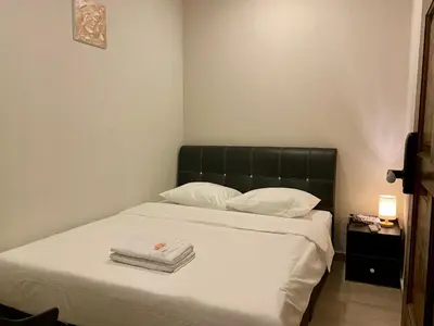 a bedroom with a bed with two towels on it at Aayu Muntri - 4 mins to Chulia St George Town in George Town
