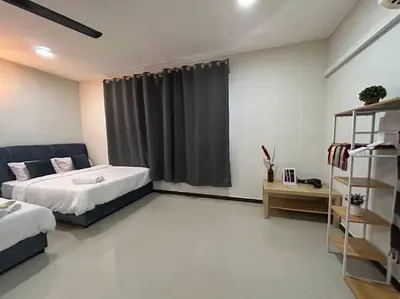 a bedroom with a bed and a window with curtains at Ipoh Comfortable Family Homestay 4R3B 12pax SY25 in Ipoh