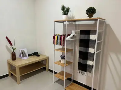a book shelf with towels and a table in a room at Ipoh Comfortable Family Homestay 4R3B 12pax SY25 in Ipoh
