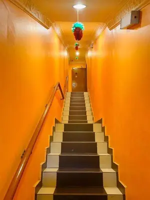 a staircase in a building with a plant on the ceiling at Kampar Times Inn Hotel in Kampar
