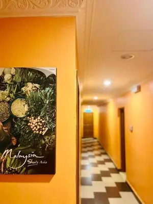 a hallway with a picture of vegetables on the wall at Kampar Times Inn Hotel in Kampar