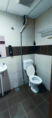 a bathroom with a toilet and a sink at Kampar Times Inn Hotel in Kampar